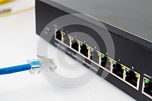 LAN network switch with ethernet cables plugging in