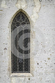 Lancet window on the wall of Parochial Church in Fiera di Primiero.