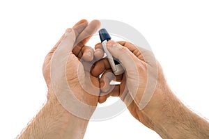 The lancing device is directed to the tip of the finger from which blood will be taken for analysis for diabetes