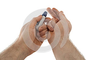 The lancing device is directed to the tip of the finger from which blood will be taken to check the blood sugar level for analysis photo