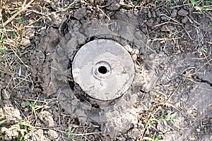 A land boundary cement pillar markers buried in the ground