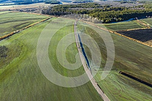 Land improvement or land amelioration concept, drone flying over narrow irrigation or drainage channels on rye or wheat field. photo