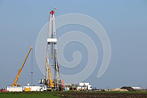 Land oil drilling rig and cranes heavy machinery