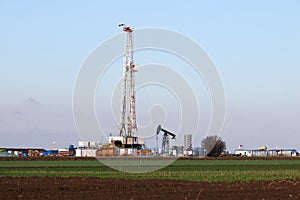Land oil and gas drilling rig and pump jack