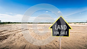 Land for sale sign against trimmed lawn background. Empty dry cracked swamp reclamation soil, land plot for housing construction