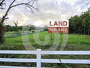 Land for sale sign on empty land