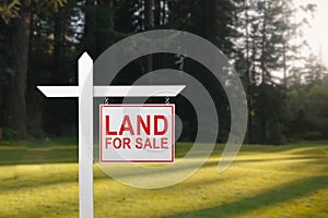 LAND FOR SALE SIGN on empty meadow - Real estate conceptual image.