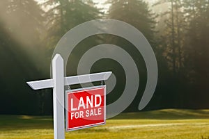 LAND FOR SALE SIGN on empty meadow - Real estate conceptual image.