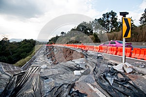 Land slide on asphalt road in thailand.land slide caused by torrential rains on asphalt road in thailand. Broken road asphalt crac