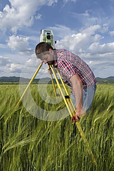 Land surveyor in agriculture field of wheat
