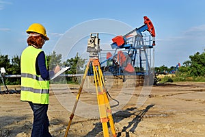 Land surveyor expert at work on an oil well