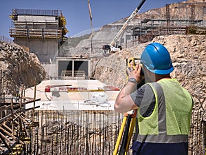 Land surveyor works at construction site