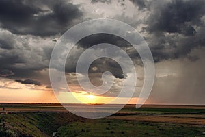 Landcape with storm clounds at sunset