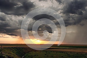 Landcape with storm clounds at sunset photo