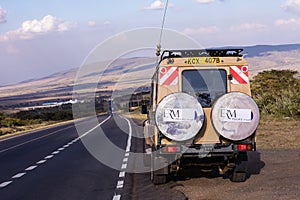 Landcruiser Toyota vehicle van parked in the Savannah grasslands of the Maasai Mara National Game Reserve park Rift Valley