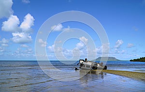 Landcruiser wreck overturned on the beach at low tide