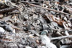 Landfill of damaged gas masks in a dilapidated concrete building of an inactive enterprise.