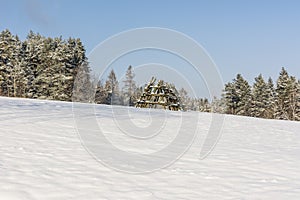 Landfill hay field on a meadow covered with snow waiting for haymaking