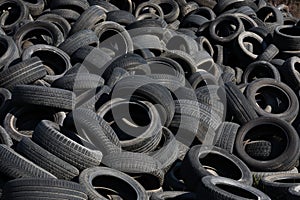 Landfill with old tires and tyres for recycling. Reuse of the waste rubber tyres. Disposal of waste tires. Worn out wheels for