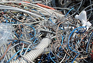 Landfill of refuse with pieces of demolished old electric cables
