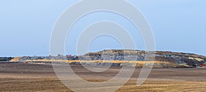 Landfill site with scattered birds flying