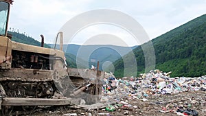 Landfill of unsorted garbage, a tractor at a landfill. Lots of plastic garbage, unsanitary