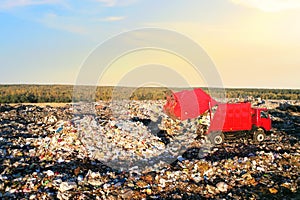 Landfill waste disposal. Garbage dump with waste plastic and polyethylene. Garbage truck unloads rubbish in landfill. Reduce