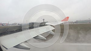 Landing of an aircraft on the runway in the fog with a view of the wing. Issue spoilers on landing.
