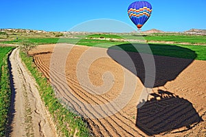 Hot air balloons landing in spring fields Cappadocia Turkey photo