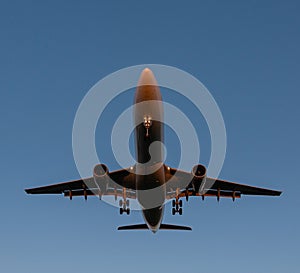 Landing passenger plane during sunset