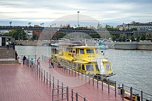 Landing of passengers to the walking motor ship to a water excursion across the Moskva River. Moscow