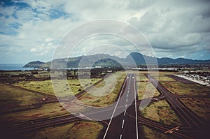 Landing road pointing to one of the peaks of Kauai, US