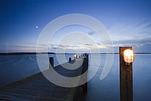 Landing stage with a little light at sunset.