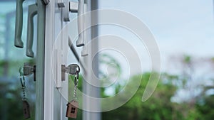 Landlord for house concept. The house key for unlocking a new house is plugged into the door.