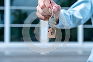 The landlord or sales representative handing over the key to the new landlord. New house move ideas, home leasing and selling home