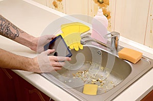 The landlord uses the tablet to call a cleaner in order to clean the clogged kitchen sink