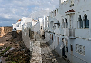 Landmark of Asilah - Atlantic Ocean Surf and Old City Wall with white houses on Seaside. Asilah, Morocco