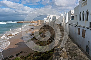 Landmark of Asilah - Atlantic Ocean Surf and Old City Wall with white houses on Seaside. Asilah, Morocco