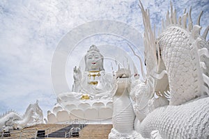 Landmark of Chiangrai & x22;Huay Pla Kang Temple& x22; - The Big White Guanyin stands amid the white cloud and blue sky