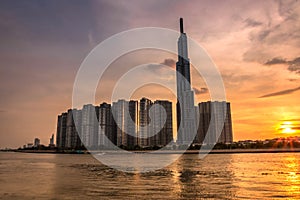 Cityscape with Wide Angle View of Landmark 81 Tower from Saigon River at Sunset photo