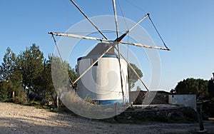 Landmark traditional windmill on forested hillslope, Rio Maior, Portugal