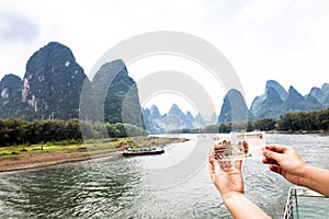 Li River and 20 Yuan Bill. The landscape depicted on the banknote is identical to the landscape surrounding the river. China  photo