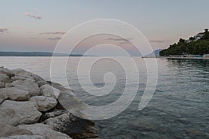 Landscape of Adriatic sea and croatian coast near tourist resort Baska voda at down in summer