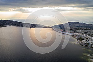 Landscape aerial drone view of Lagoa comprida lake and Marques da Silva dam in Serra da Estrela, Portugal at sunset