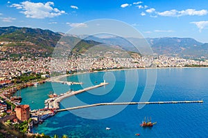 Landscape of Alanya with marina and Kizil Kule red tower in Antalya district, Turkey, Asia. Famous tourist destination with high