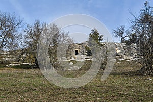 Landscape with an ancient cave dwelling in the rock in the background