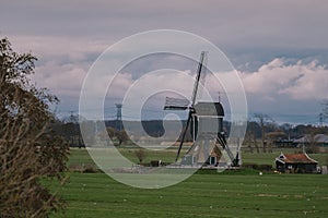Landscape with ancient windmills in the Netherlands in gloomy spring weather. Stormy day over Dutch village of Streefkerk