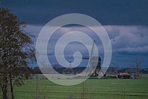 Landscape with ancient windmills in the Netherlands in gloomy spring weather. Stormy day over Dutch village of Streefkerk