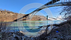 Landscape of the arched bridge over a river on the background of Niagara Falls