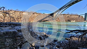 Landscape of the arched bridge over a river on the background of Niagara Falls